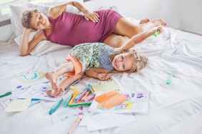 Mother playing and drawing with her baby daughter