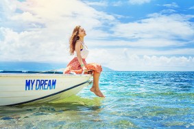 dream concept: woman sitting in a beautiful boat