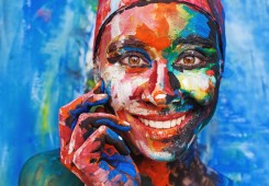 Living painting - smiling woman completely covered with thick pa