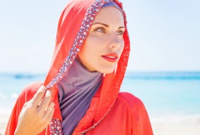 beautiful muslim caucasian (russian) woman wearing red dress rel
